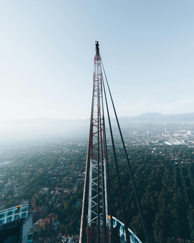 Aerial view of a construction site with a towering crane in Mexico City highlighting urban development.